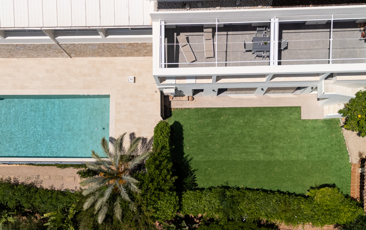 Aerial drone view of luxury villa terrace with swimming pool and private garden in Palma, Mallorca