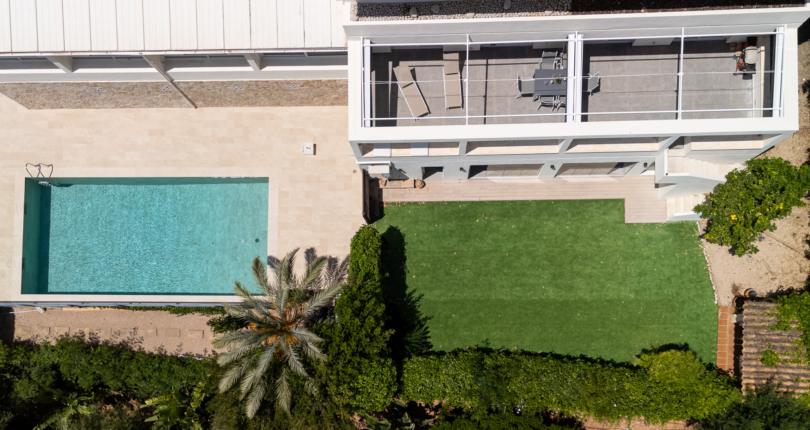 Aerial drone view of luxury villa terrace with swimming pool and private garden in Palma, Mallorca